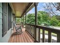 Cozy covered front porch with rocking chairs and a serene neighborhood view at 1235 Waterwood Dr, Loganville, GA 30052