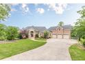 Beautiful brick home featuring a three-car garage, curved driveway, and a lush, well-maintained lawn at 3718 Lake Vis, Douglasville, GA 30135
