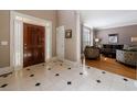 Bright foyer with tile flooring, leading to a living area with a dark wood door and white trim at 1021 Oakpointe Pl, Dunwoody, GA 30338