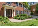 The front of the property features manicured landscaping, an iron door, and a three-car garage at 1850 Linnet Ne Ct, Roswell, GA 30075