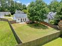 Spacious, fenced backyard featuring a well-maintained lawn and inviting deck, perfect for outdoor entertaining at 3020 River Oak Mews, Decatur, GA 30034