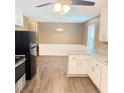 Eat-in kitchen with sleek appliances, white cabinets, and luxury vinyl flooring at 401 Mount Tabor Church Rd, Dallas, GA 30157