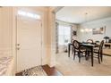 Inviting dining room with a chandelier, a dining table set for four, and large windows for natural light at 555 Lance View Ln, Lawrenceville, GA 30045