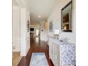 Bright entryway with hardwood floors, elegant wainscoting, a decorative mirror, and a view into the living area at 555 Lance View Ln, Lawrenceville, GA 30045