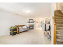 Spacious living room featuring a cozy fireplace and staircase at 6540 Arbor Gate Sw Dr # 3, Mableton, GA 30126