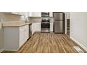 Bright kitchen with stainless steel appliances, granite countertops, and hardwood floors at 2641 Clifton Springs Rd, Decatur, GA 30034