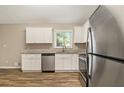 Modern kitchen featuring white cabinets, granite countertops, and stainless steel appliances at 2641 Clifton Springs Rd, Decatur, GA 30034