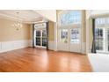 Bright dining area with hardwood floors, wainscoting, and a chandelier next to the front entryway at 3505 Belridge Ln, Smyrna, GA 30080