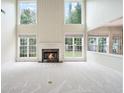 Bright living room features soaring ceilings, many windows, and a cozy fireplace at 3505 Belridge Ln, Smyrna, GA 30080
