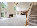 Spacious living room with a cozy fireplace and staircase leading to the second floor at 3505 Belridge Ln, Smyrna, GA 30080