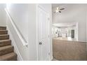 Inviting entryway featuring a staircase, coat closet, and open view into the kitchen at 3658 Madison St, College Park, GA 30337