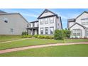 Lovely two-story home showcasing a lush green lawn and attractive landscaping at 3658 Madison St, College Park, GA 30337