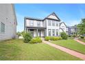 Beautiful home featuring a lush lawn and a charming brick walkway to the front door at 3658 Madison St, College Park, GA 30337