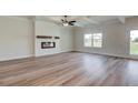 Open-concept living room features hardwood floors, an electric fireplace, and backyard access at 4504 Eastbrook Pl, Snellville, GA 30039