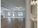 Spacious living room features hardwood floors, neutral paint and natural light from several windows at 4554 Eastbrook Pl, Snellville, GA 30039