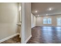 Open living space with luxury vinyl plank flooring, recessed lighting, and a view to the outdoors at 4554 Eastbrook Pl, Snellville, GA 30039