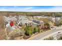 An aerial view shows an expansive townhome community surrounded by lush, mature trees at 2555 Flat Shoals Road Rd # 1104, College Park, GA 30349