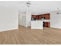 Open-concept living room with ceiling fan and adjacent kitchen featuring wooden cabinets at 2555 Flat Shoals Road Rd # 1104, College Park, GA 30349