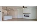 Open-concept living room with white cabinets, a fireplace and wood-style flooring at 4524 Eastbrook Pl, Snellville, GA 30039