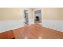 Open dining room featuring hardwood floors with view of kitchen, living room and modern lighting at 4544 Dorsett Shoals Run, Douglasville, GA 30135