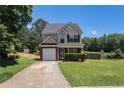 Charming two-story home featuring a brick facade, well-manicured lawn and attached garage at 752 Wood Bend Ct, Riverdale, GA 30296