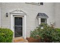 Close up of townhouse entryway with charming accents and well-maintained landscaping at 1771 Defoor Nw Ave # D, Atlanta, GA 30318