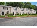 Row of charming townhouses featuring brick facade, manicured lawns, and ample parking at 1771 Defoor Nw Ave # D, Atlanta, GA 30318
