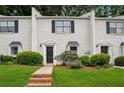 Charming townhouse with brick facade, well-maintained lawn, and black shutters on light colored brick at 1771 Defoor Nw Ave # D, Atlanta, GA 30318
