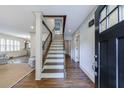 Inviting foyer featuring hardwood floors, staircase, and an open view into the living area at 2668 Jefferson Ter, East Point, GA 30344