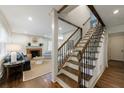 Welcoming foyer with staircase leading to the upper level, adjacent to the living room with fireplace at 2668 Jefferson Ter, East Point, GA 30344