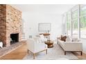 Spacious living room with a brick fireplace, large windows, and neutral-toned furniture for a comfortable atmosphere at 2873 Bob White Sw Dr, Atlanta, GA 30311