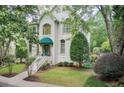 Charming home featuring lush landscaping, a neatly maintained lawn, and an inviting entrance at 42 Greenland Trce, Atlanta, GA 30342