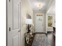 Inviting foyer with hardwood floors, elegant lighting, and a view to the dining room at 830 Nottingham Se Dr, Smyrna, GA 30082