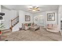 Inviting living room with plush carpeting, staircase, and neutral walls providing a comfortable and stylish atmosphere at 5152 Rapahoe Trl, Atlanta, GA 30349
