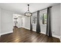 Dining room with wood flooring and a modern chandelier, with natural light at 500 Gardenia Ln, Marietta, GA 30068