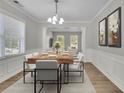 Elegant dining room with modern chandelier, stylish wood table, and neutral decor for Gathering gatherings at 955 Mill Creek Ave, Canton, GA 30115