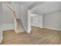 Inviting living area featuring wood floors, staircase with wood trim, and an open layout at 955 Mill Creek Ave, Canton, GA 30115