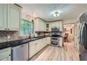 Well-lit kitchen features stainless steel appliances, granite countertops, and tile backsplash at 1580 Smyrna Sw Rd, Conyers, GA 30094