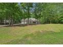 Well-kept home with mature trees and a large yard at 25 Pebble Creek Dr, Covington, GA 30016
