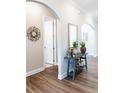 Welcoming hallway with beautiful wood floors, arched doorways and a console table at 2665 Crowbrook Way, Cumming, GA 30040