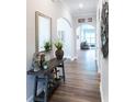 Inviting entryway with hardwood floors, decorative accents, and arched doorways at 2665 Crowbrook Way, Cumming, GA 30040