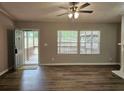 Bright living room with wood floors and a view of the covered porch through large windows at 85 Holly Dr, Carrollton, GA 30116