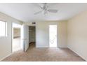 Neutral bedroom featuring a ceiling fan and doorways leading to an ensuite bathroom at 346 Carpenter Dr # 70, Atlanta, GA 30328