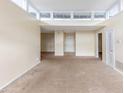A spacious living room with neutral tones boasts a large doorway and an entry door at 346 Carpenter Dr # 70, Atlanta, GA 30328