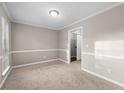 Carpeted bedroom with neutral walls, crown molding, and a closet at 470 Piney Sw Way, Atlanta, GA 30331