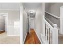 Hallway with hardwood flooring and a staircase leading to the upper level at 470 Piney Sw Way, Atlanta, GA 30331