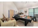 Bright living room with a vaulted ceiling and large windows offering ample natural light at 4732 Browns Mill Ferry Rd, Lithonia, GA 30038