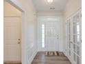 Bright entryway featuring hardwood floors, wainscoting, and a view into other rooms at 502 Helene Ct, Woodstock, GA 30188