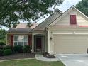 Charming single Gathering home with a well-manicured lawn, two-car garage, and a welcoming front porch at 502 Helene Ct, Woodstock, GA 30188