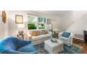 Cozy living room with large window, comfortable seating and hardwood flooring at 522 Trabert Nw Ave, Atlanta, GA 30309